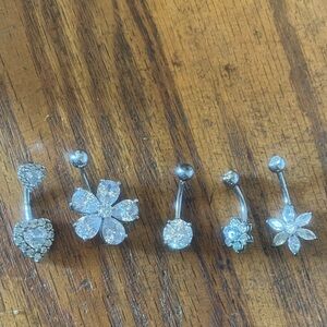 Five belly button silver piercings